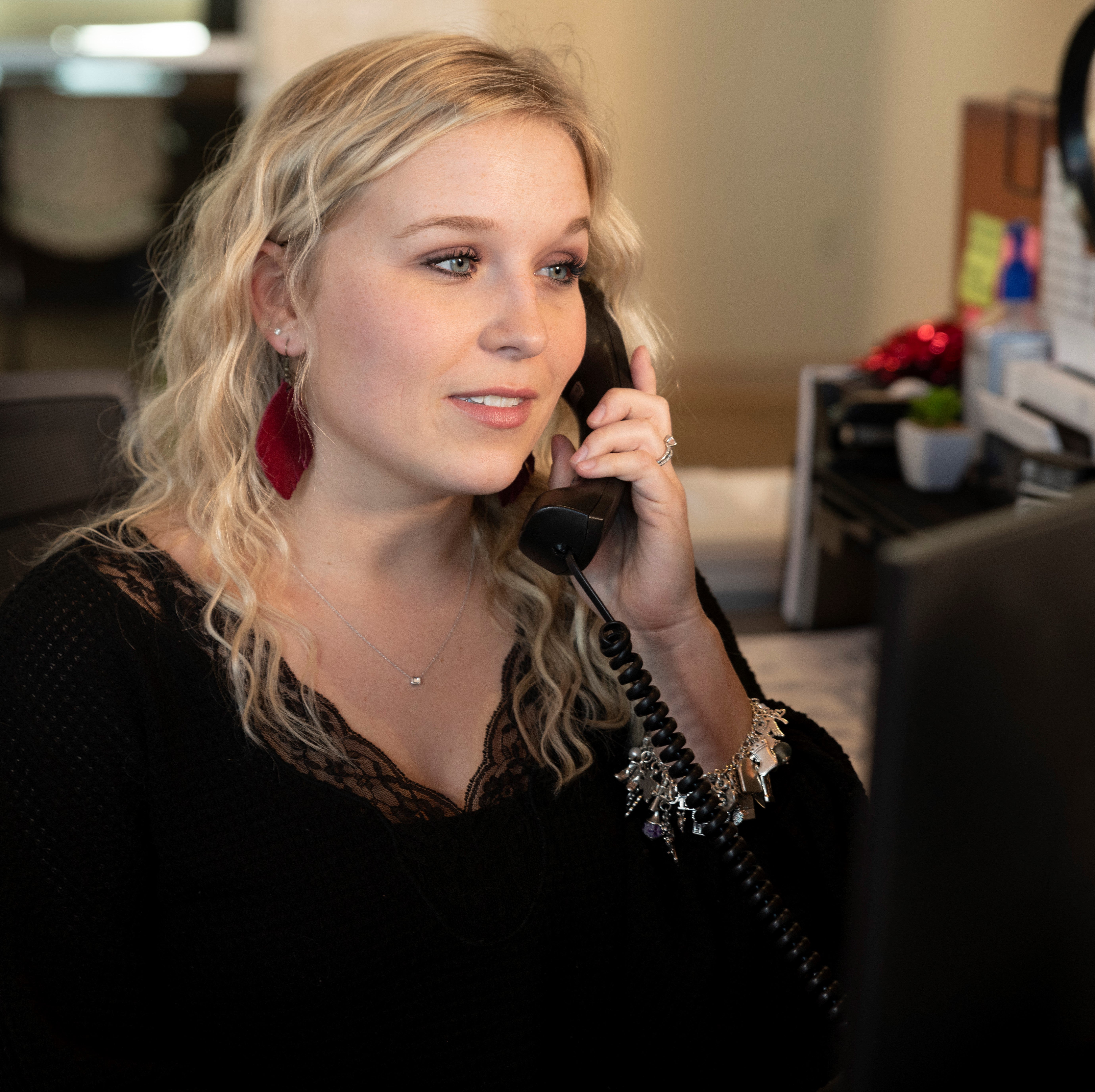 Photo of employee answering phone call. 